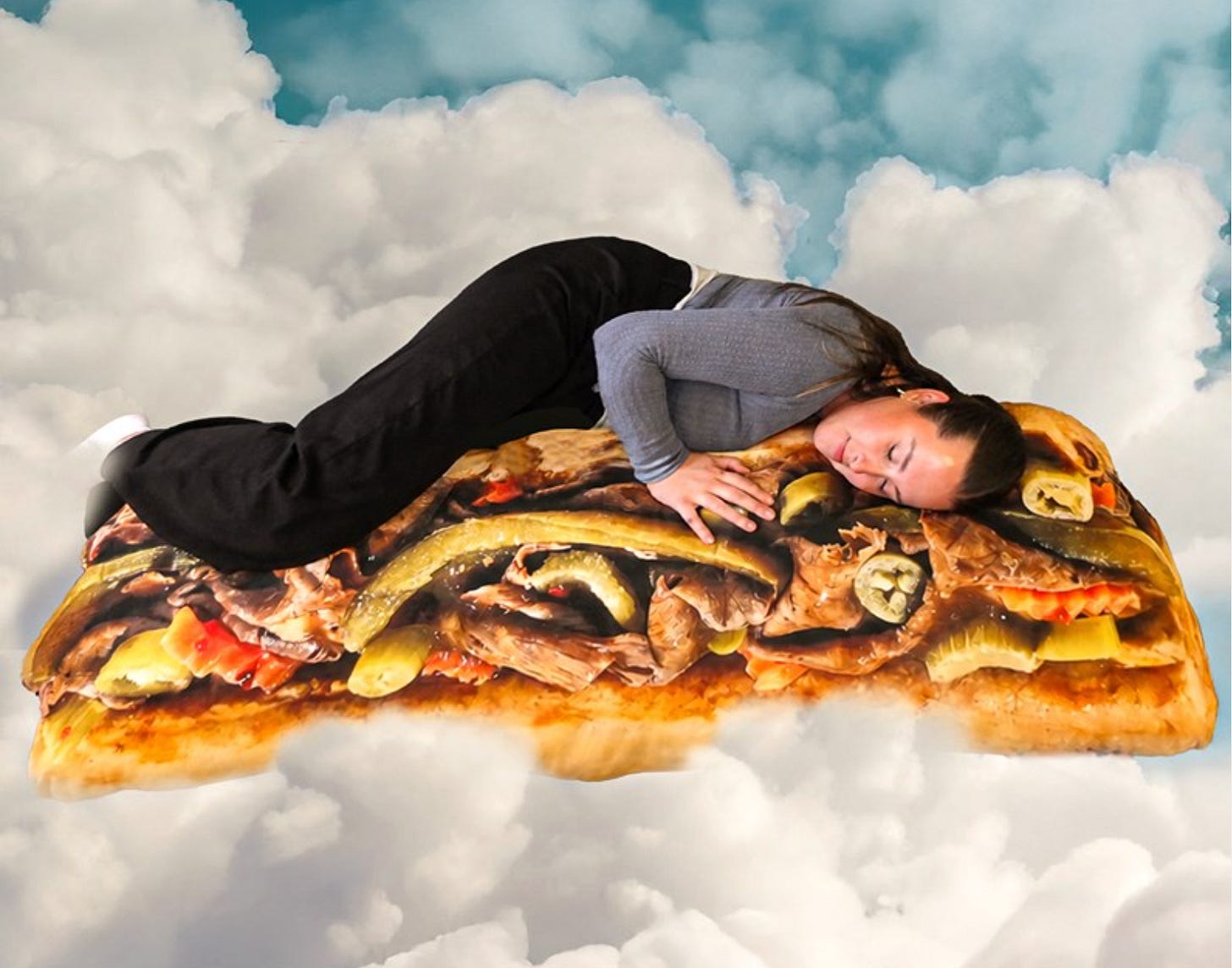 A woman laying on a giant sandwich-like pillow surrounded by clouds