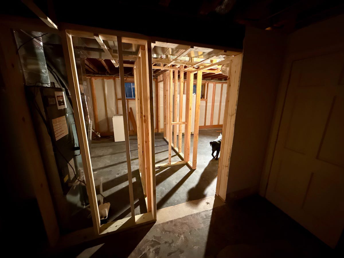 Photo of basement stud walls being erected.