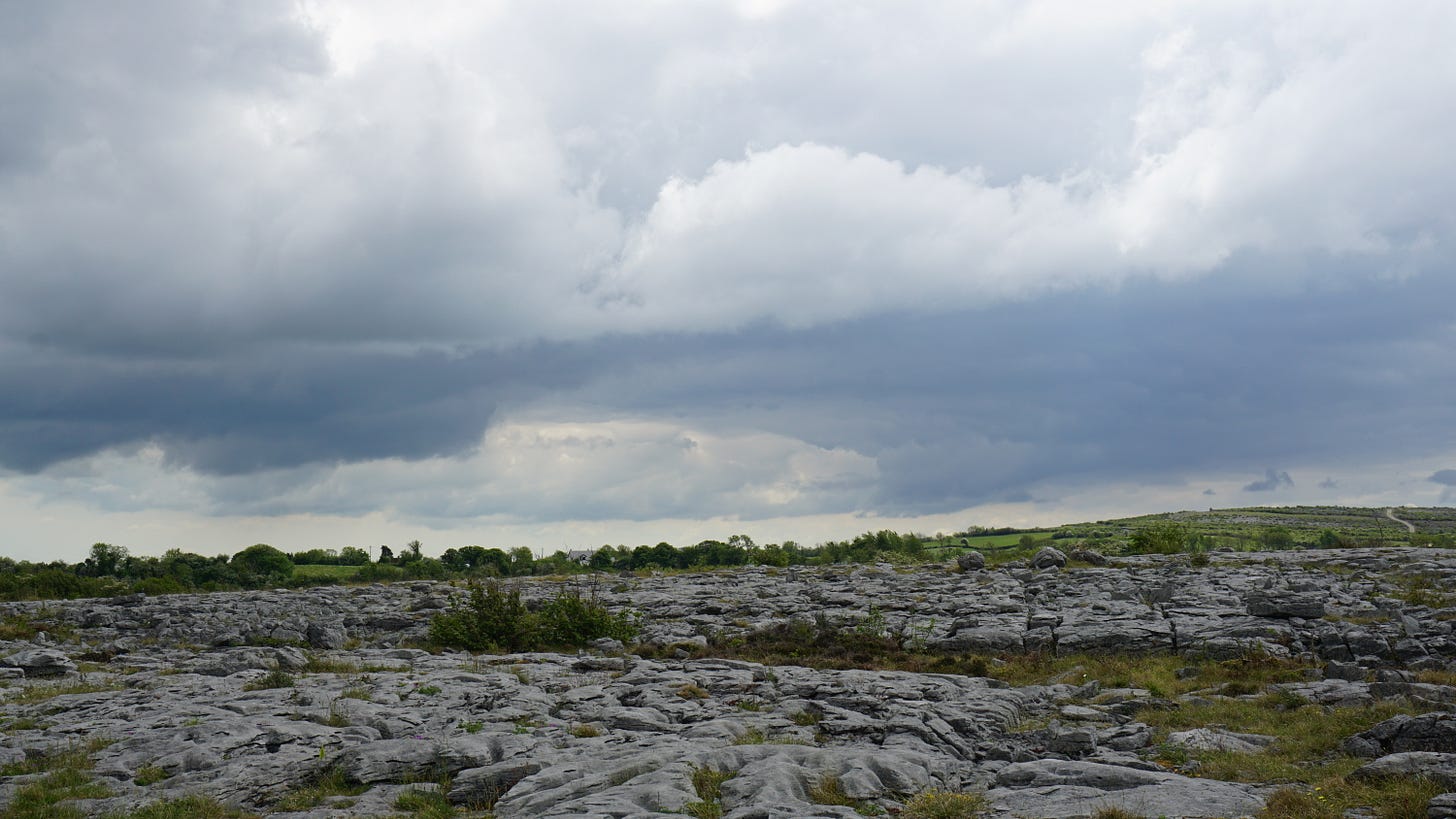Dark clouds hang over a barren landscape called the Burren in Ireland Dark clouds hang over a barren landscape called the Burren in Ireland