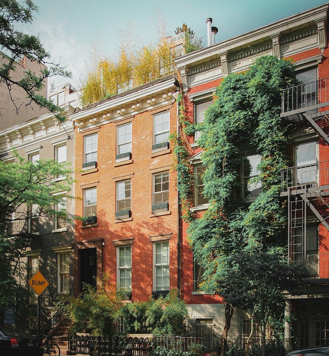 brown concrete building near green trees during daytime