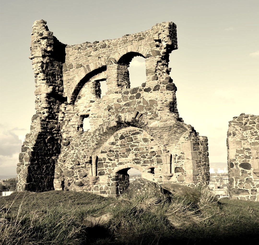 the ruins of an old castle on a hill