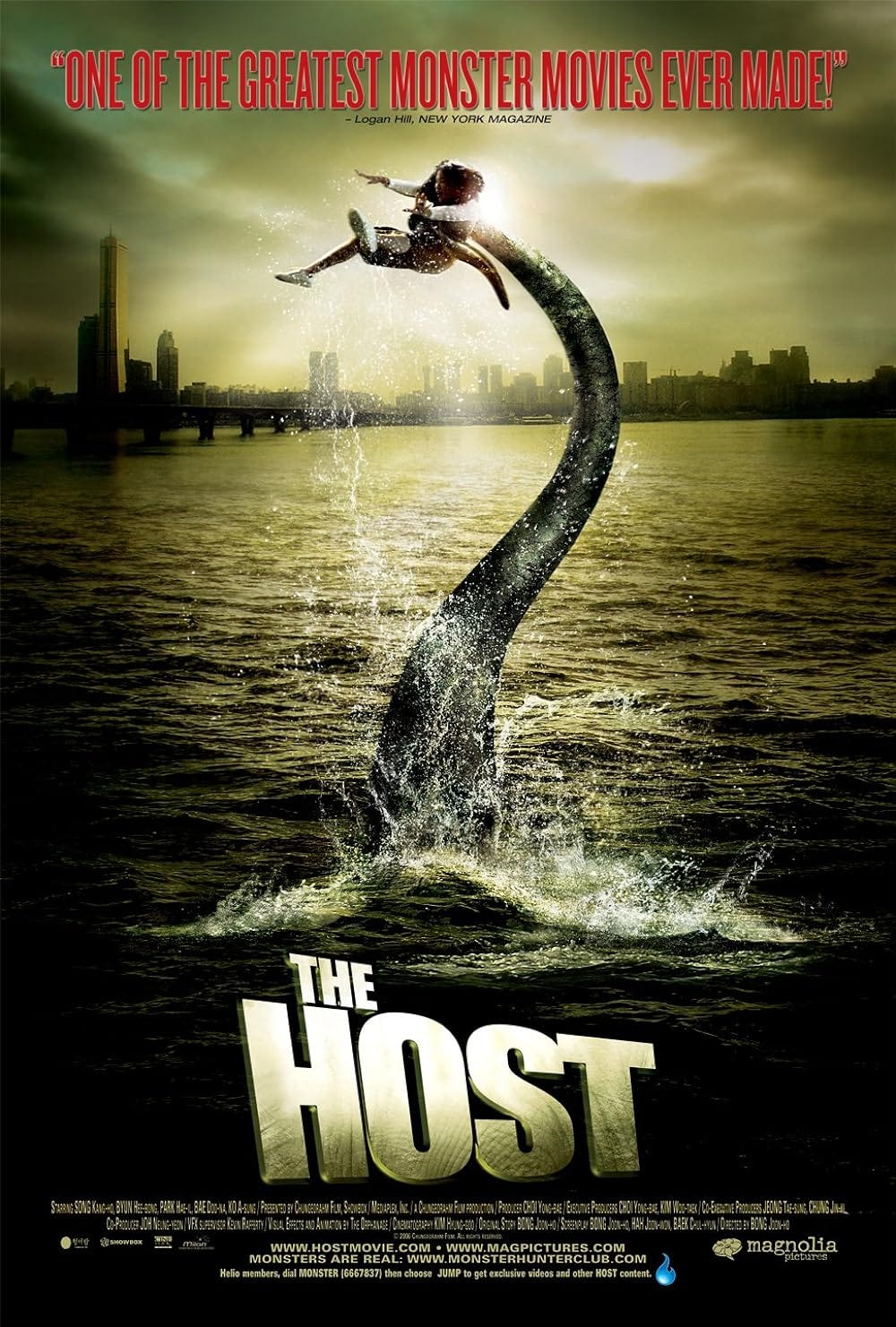 A woman being grabbed and pulled by a tentacle rising from a bay, with a city scape behind them. 