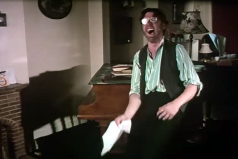 Still from "The Funniest Joke in the World" showing a man collapsing in mirth, clutching the joke. His name is Ernest Scribbler, and he is about to die. Still from "The Funniest Joke in the World" showing a man collapsing in mirth, clutching the joke. His name is Ernest Scribbler, and he is about to die.