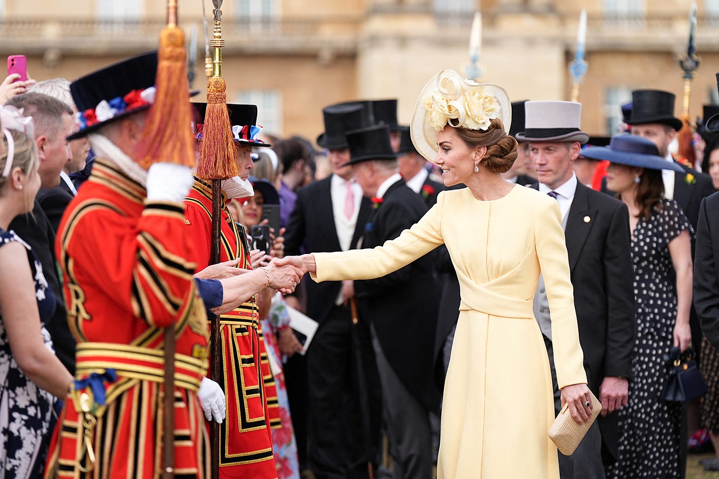 Princess Catherine shaking hands in a crowd