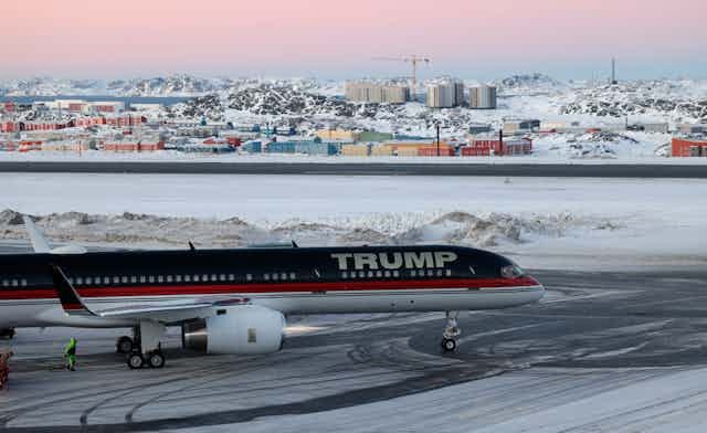 A plane on a snowy tarmac A plane on a snowy tarmac