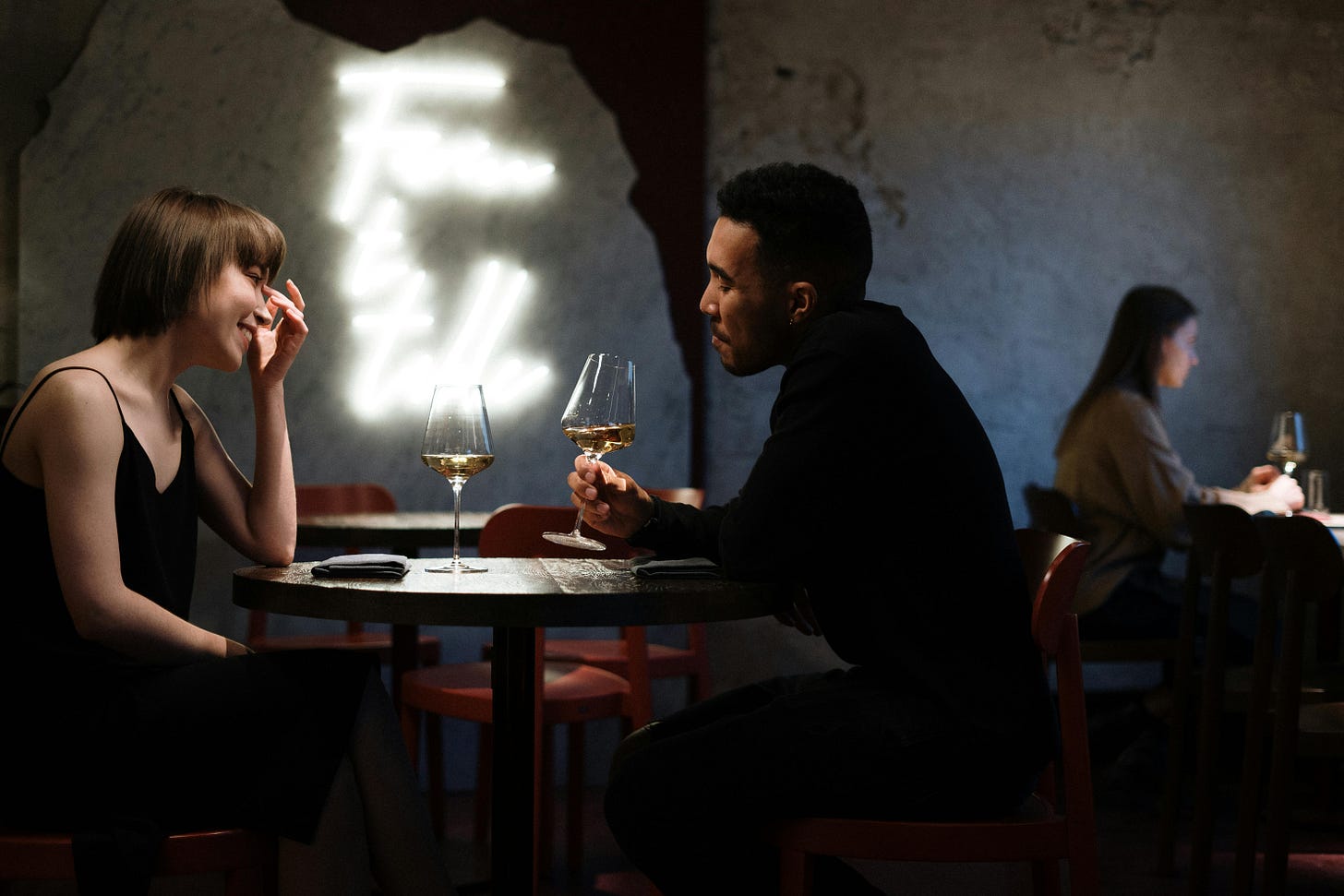 Two people on a date in a wine bar. Two people on a date in a wine bar.