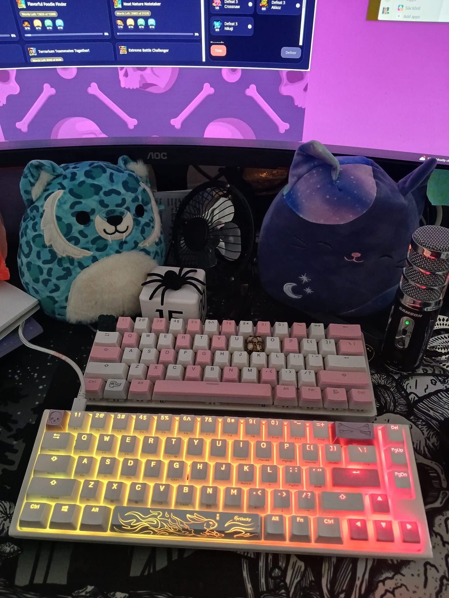 two keyboards for size comparison, both are white with some pink keycaps. also, two squishmallows. 