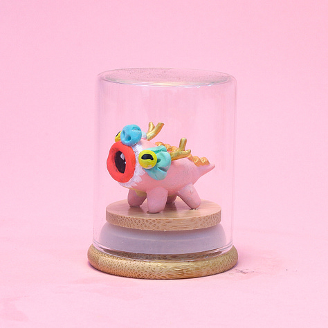 6 images of baby dragon sculptures each in a small glass jar