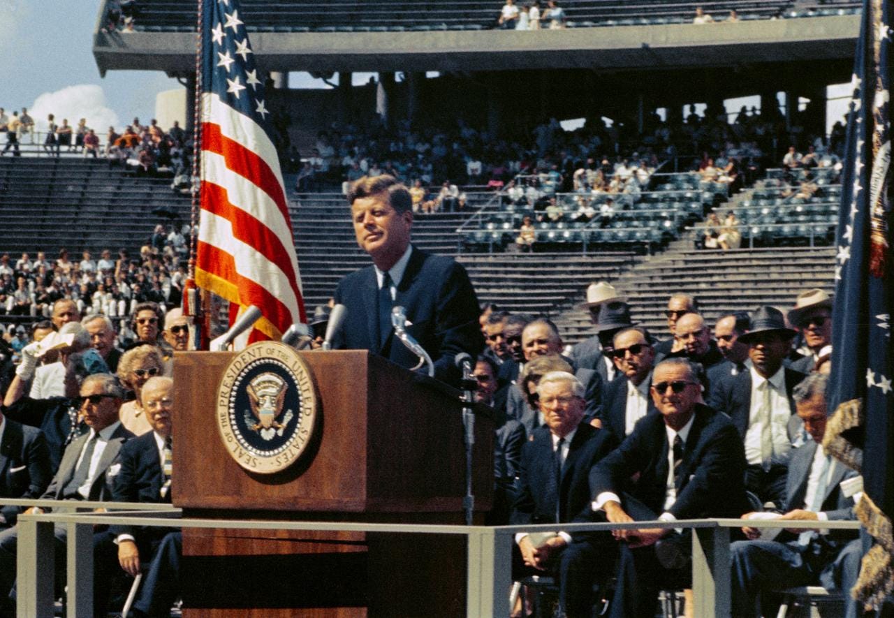 Speech at Rice Stadium, President Kennedy standing at lectern.
 
 HOUSTON, TX
 
 CN
