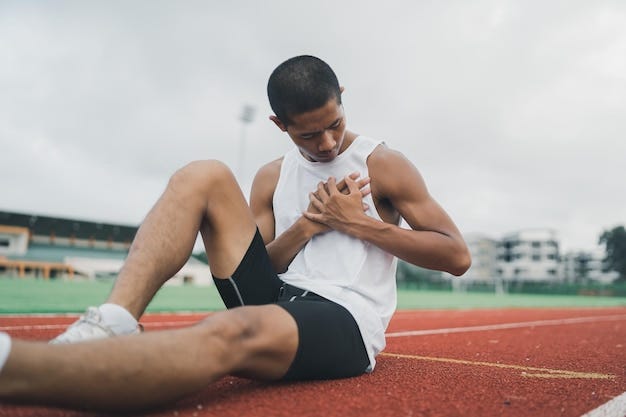 Premium Photo | Asian athletes sport man runner sitting having pain in the  chest due to heart disease or heart attack after practicing on running  track at stadium copy space Runner sport