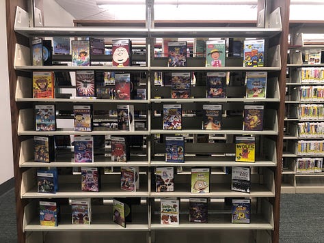 People in library borrowing books, browsing, reading 