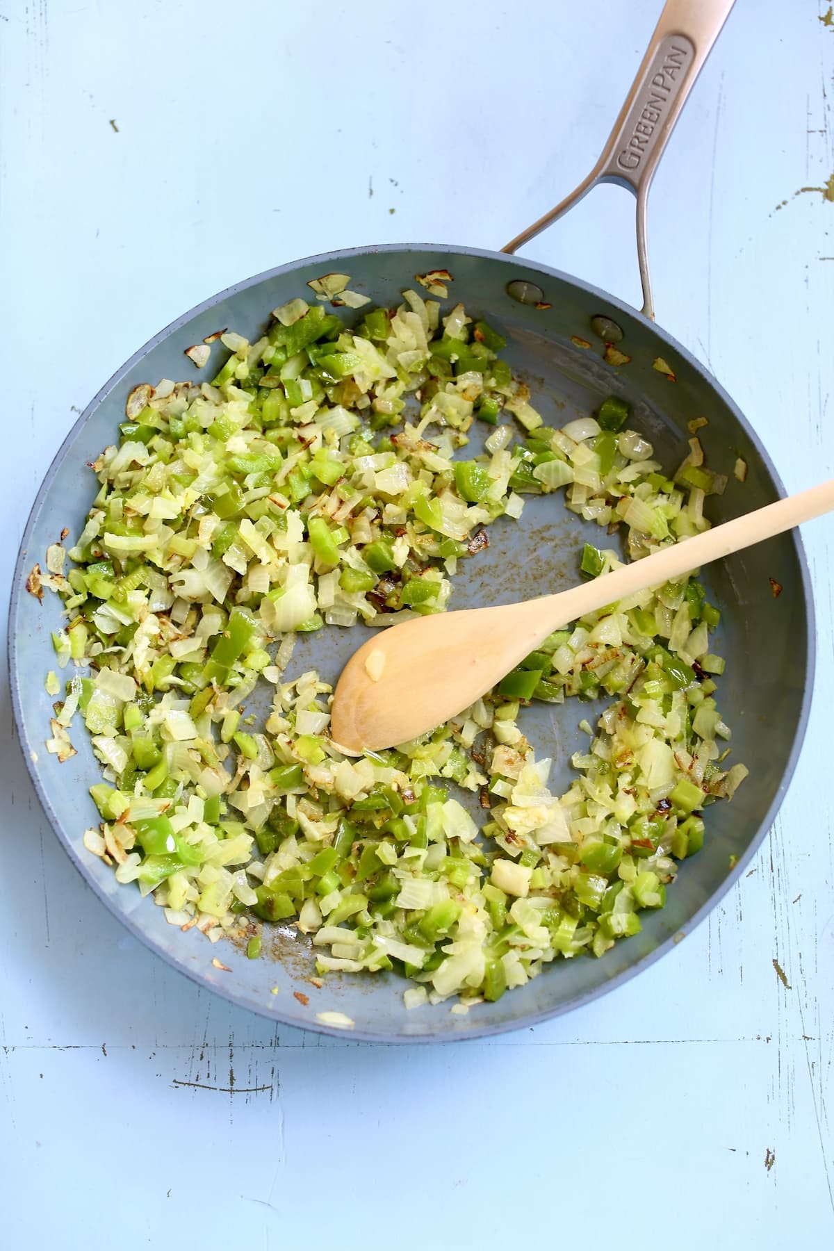 a skillet of sauteed green chili and onion.