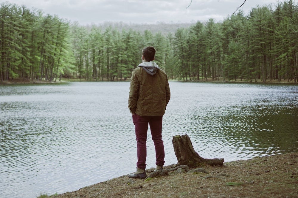 man standing near body of water