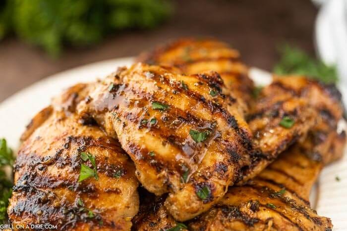 Close up image of grilled boneless chicken thighs. 