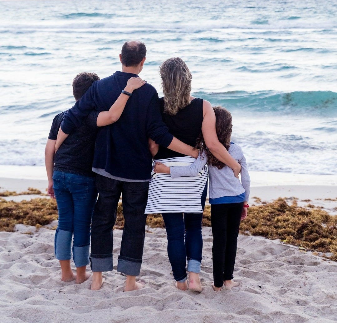 a family of four on a beach a family of four on a beach
