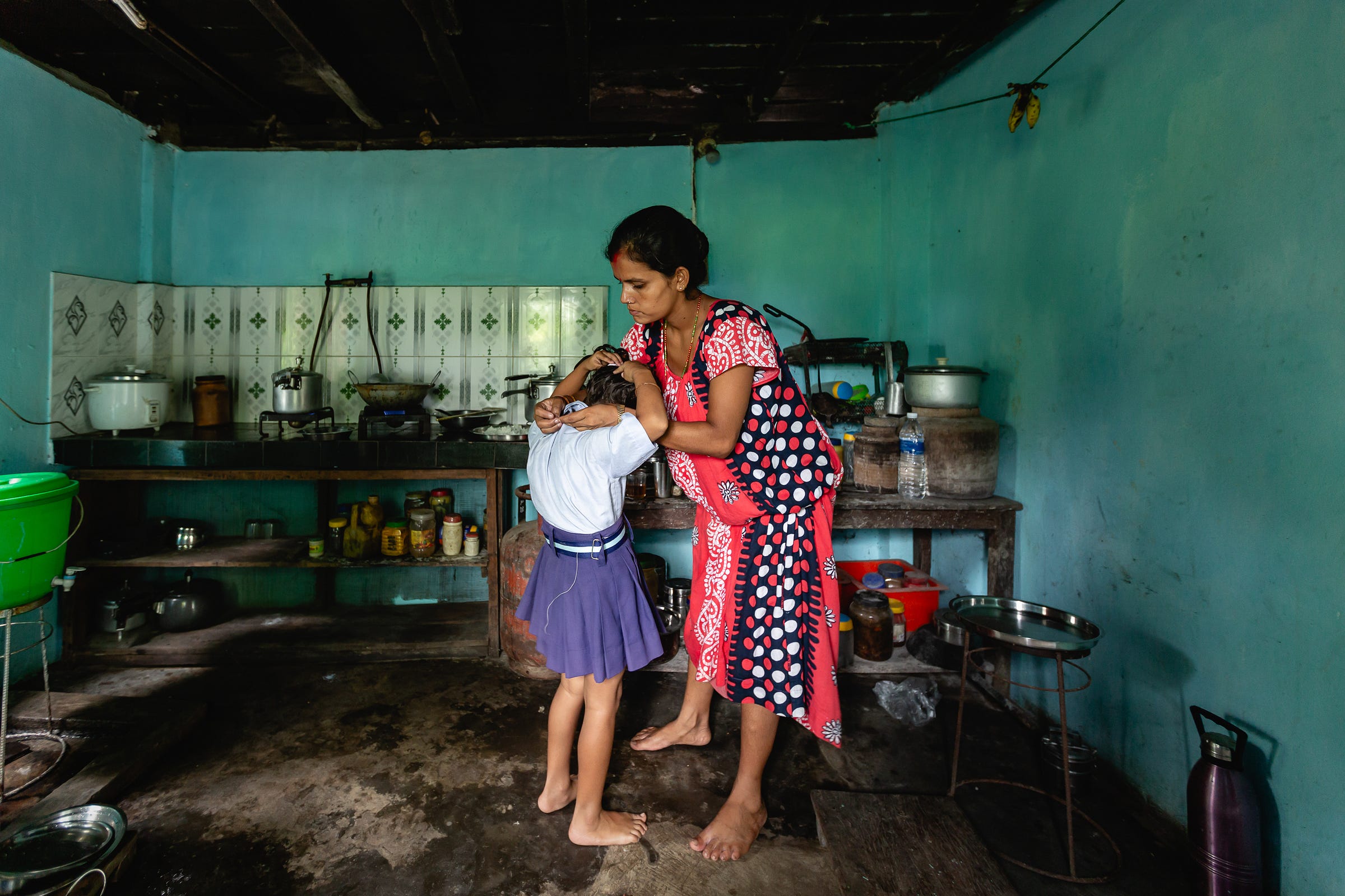 Tara Dahal helps her daughter prepare for school, Sharanamati Village, Nepal. 1/30, ƒ/2.8, ISO 800, 16mm. © Gavin Gough