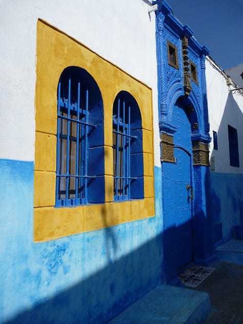 Three photos from Morocco: 1- Gold embossed design next to intricate bright tilework on a wall. 2- bright blue and white walls with an arched window painted with a yellow frame. 3- a gorgeous arched double doorway with light streaming through to shine on a detailed tile floor.