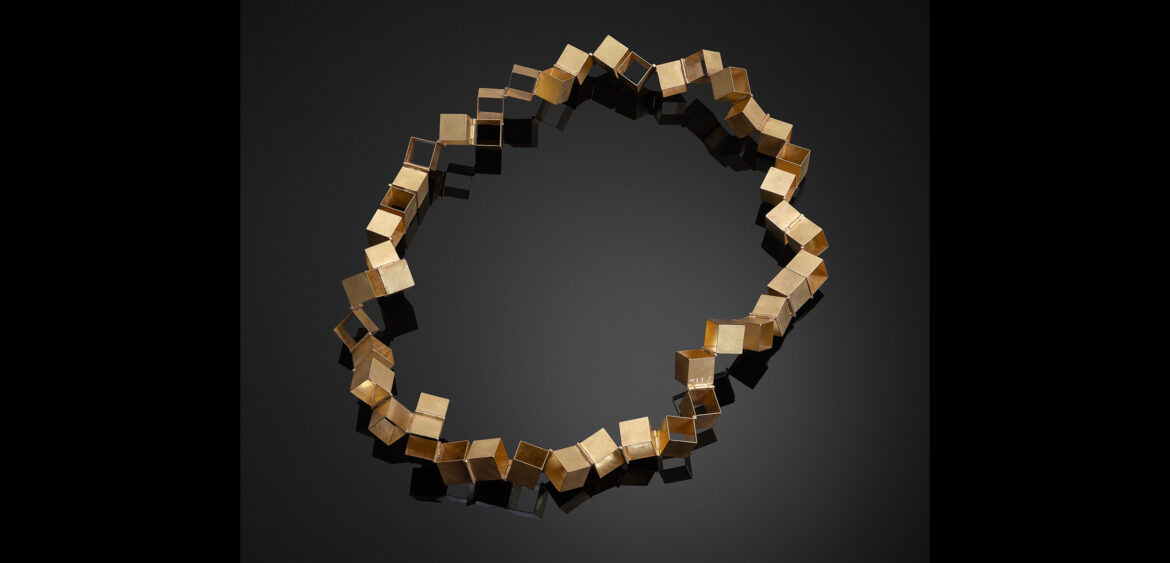 Gold necklace of hinged cubes