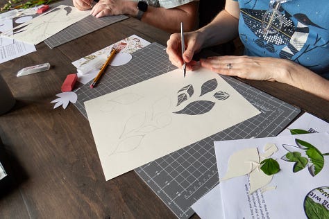 Participants working on their stencil paintings
