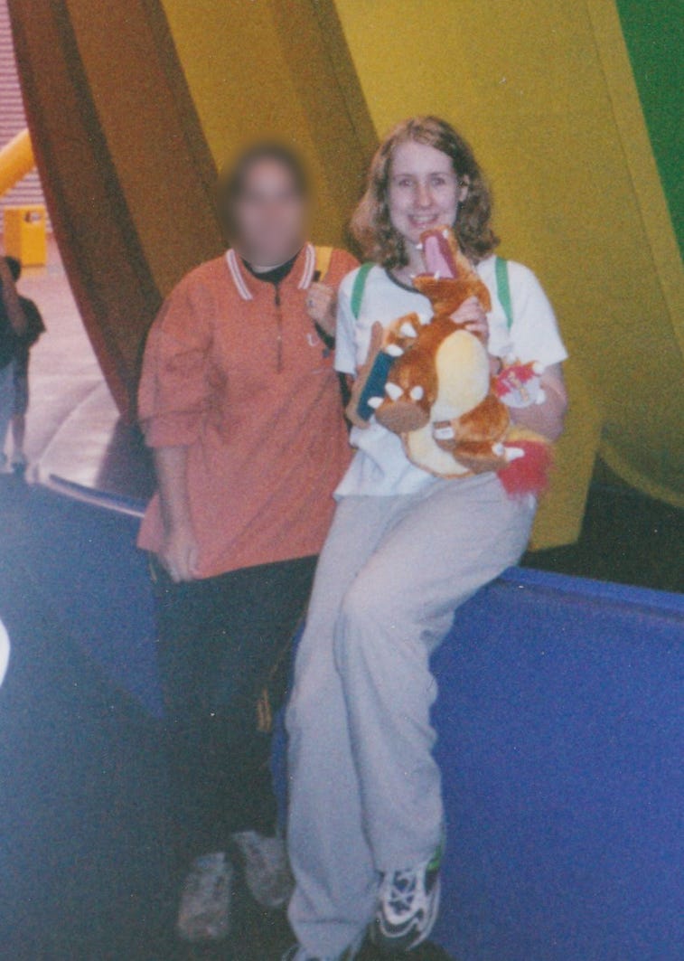 Gemma with her Charizard plush toy from the Pokémon World Exhibition at the Millennium Dome