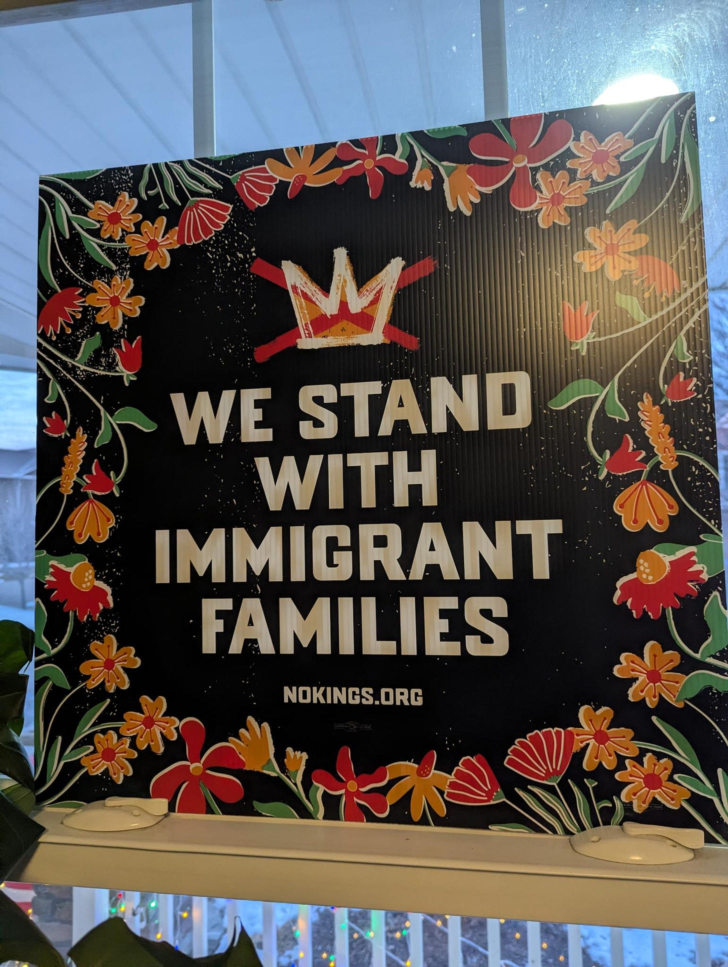 Photo of a We Stand With Immigrant Families sign