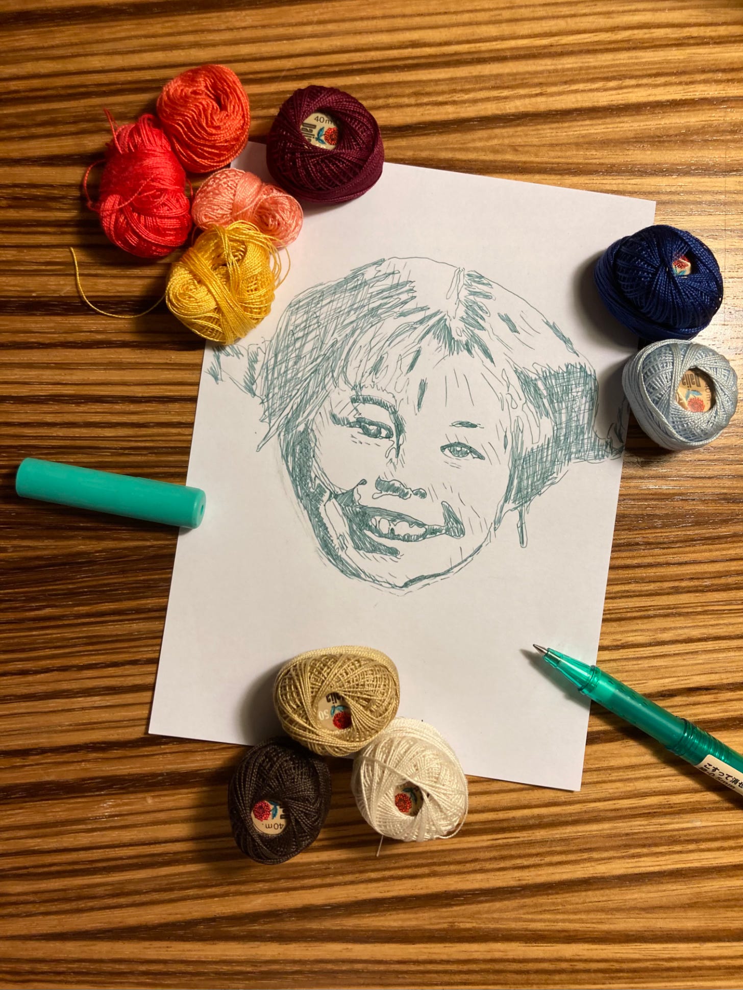 Sketch of Pippi Langstrumpf head surrounded by balls of thread.