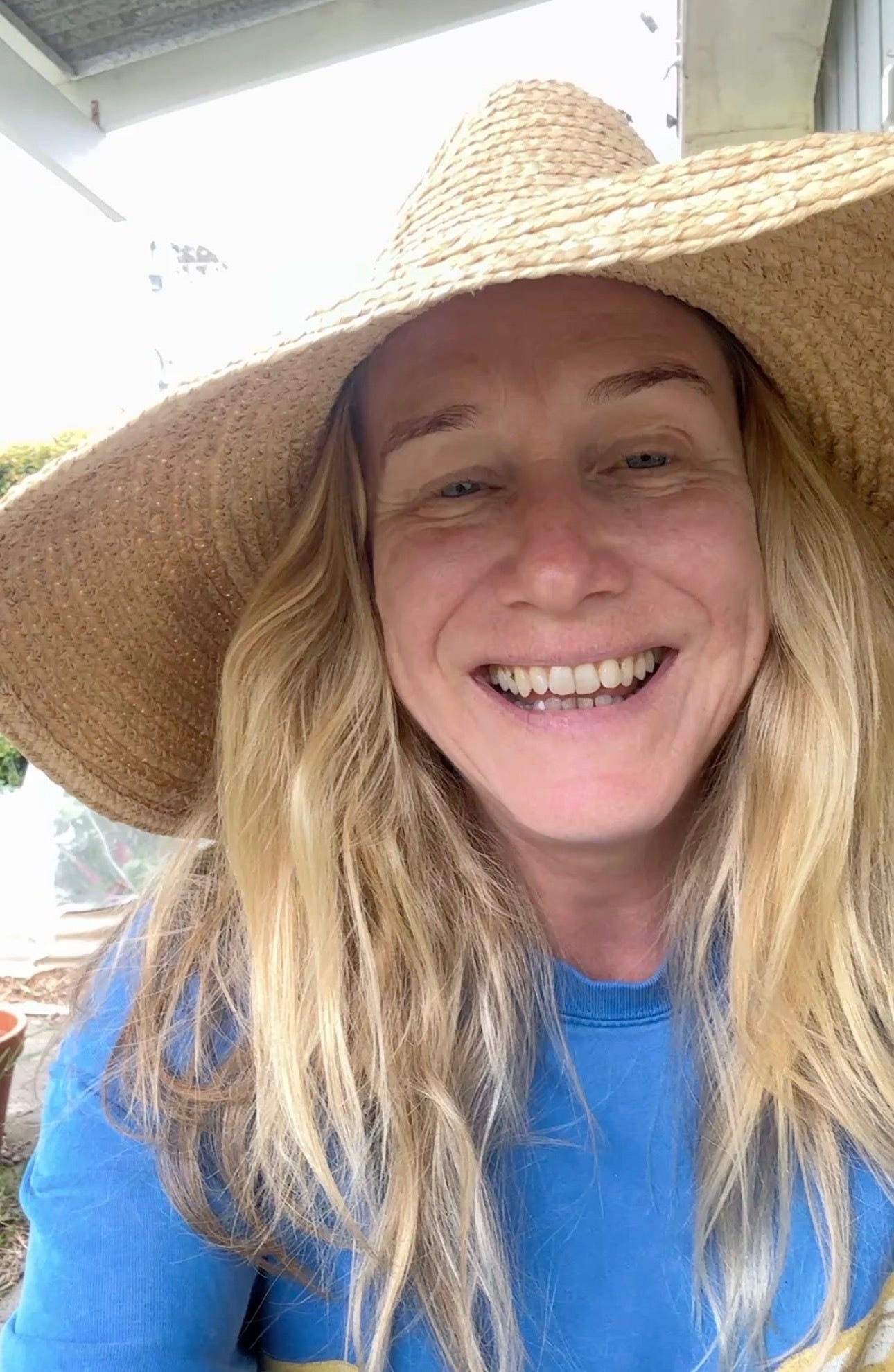 Holly smiles in raffa wide brim hat.