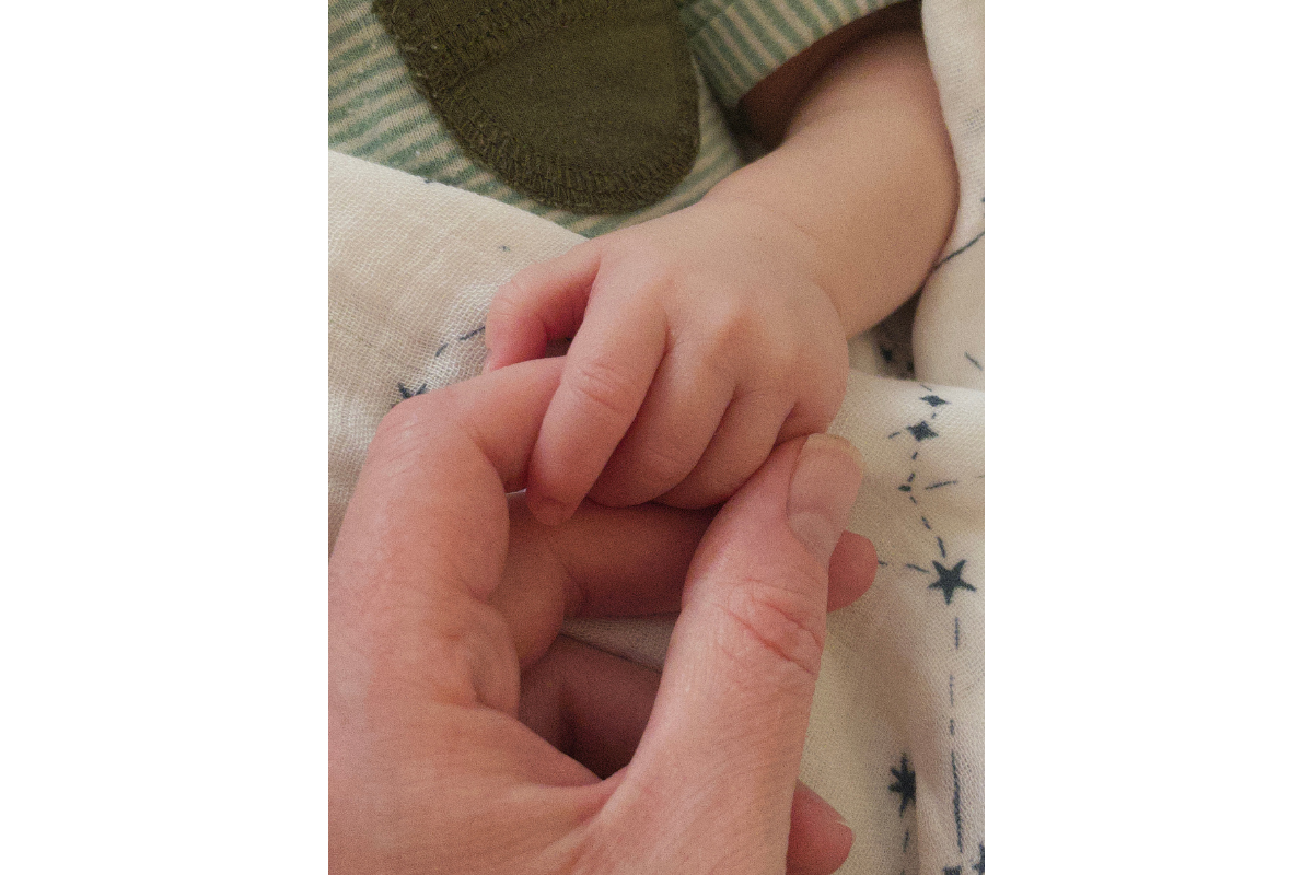 Critter holding Eliza's finger
