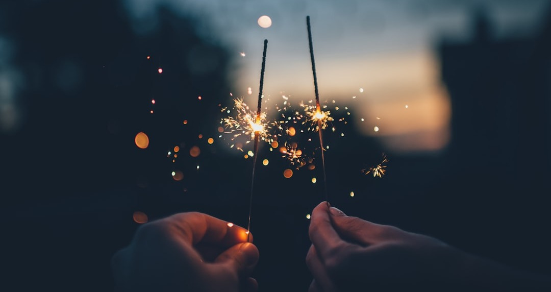 person holding fire cracker shallow focus photography person holding fire cracker shallow focus photography