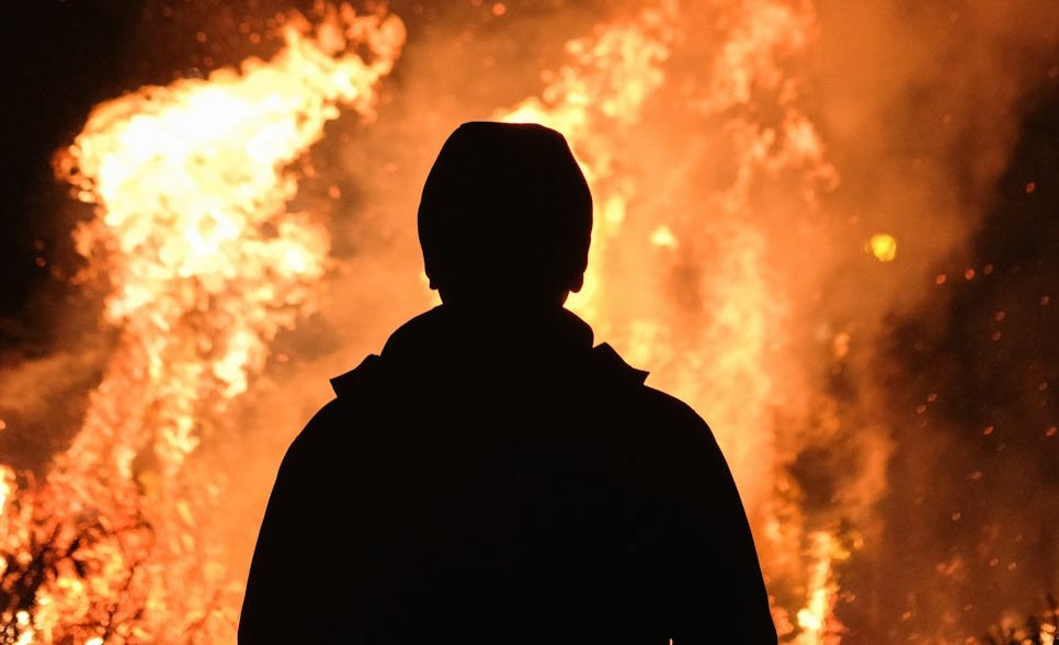person standing in front of fire person standing in front of fire