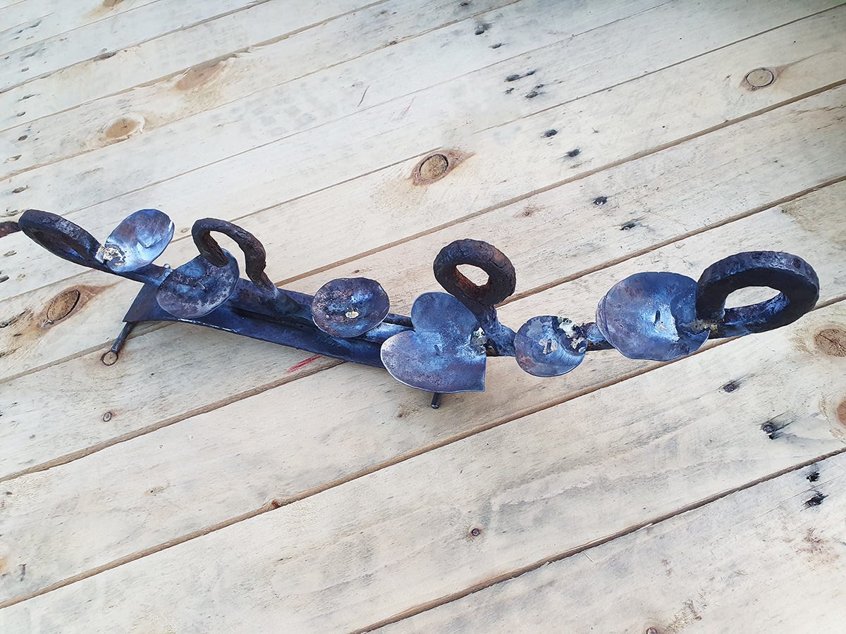 A recycled metal candelabra, an example of the simplicity of the final artifact. After the choas of making and all the design thinking. Still to be finished.