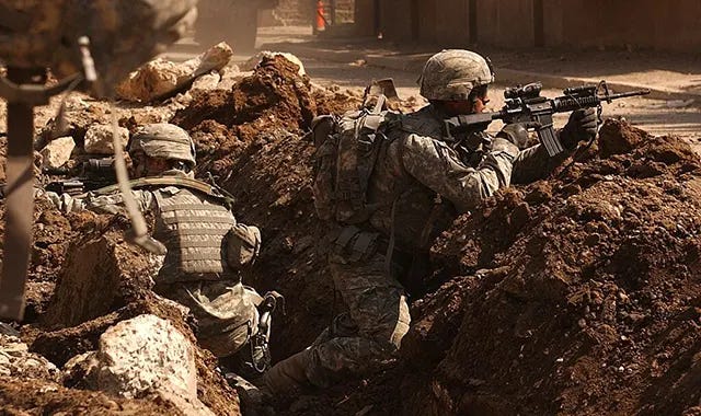 US soldiers take cover during intense street fighting with insurgents in the Al Doura section of Baghdad on March 7, 2007. US soldiers take cover during intense street fighting with insurgents in the Al Doura section of Baghdad on March 7, 2007.
