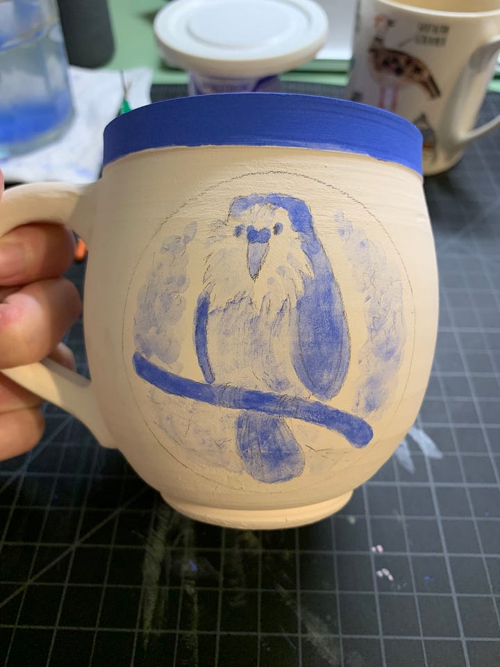 ceramic mugs and a saucer in different phases of the illustration process using underglaze and a slip trailer by Kayla Stark