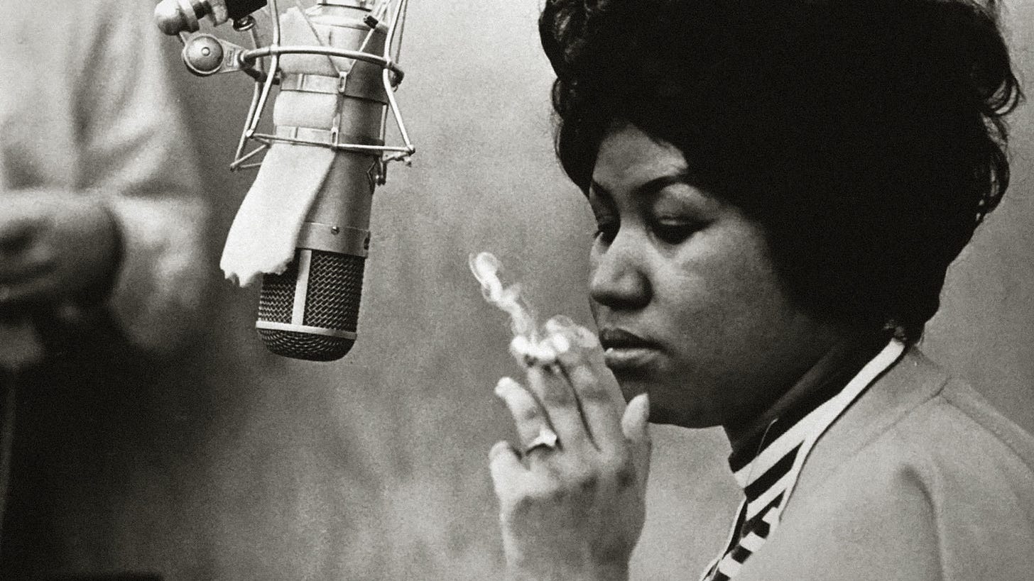 Aretha Franklin, smoking, in a recording studio.