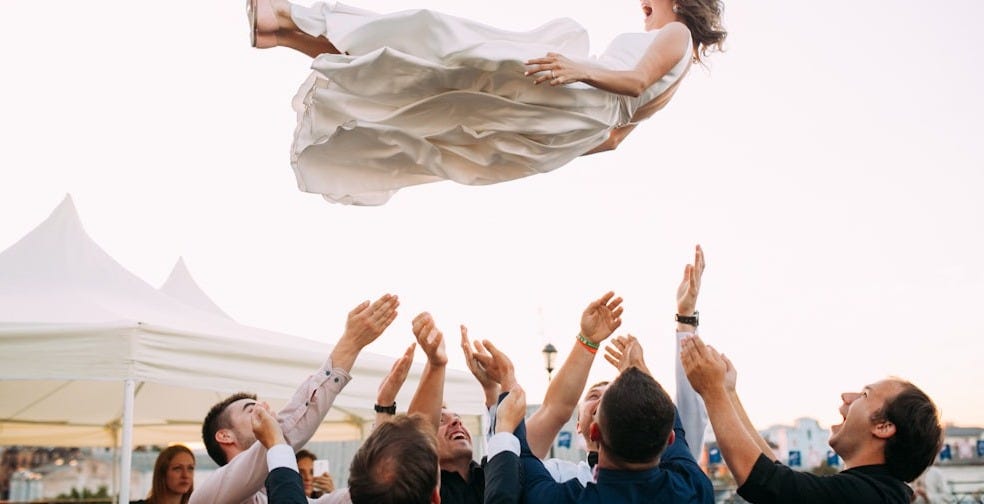 people lifting woman in the air people lifting woman in the air