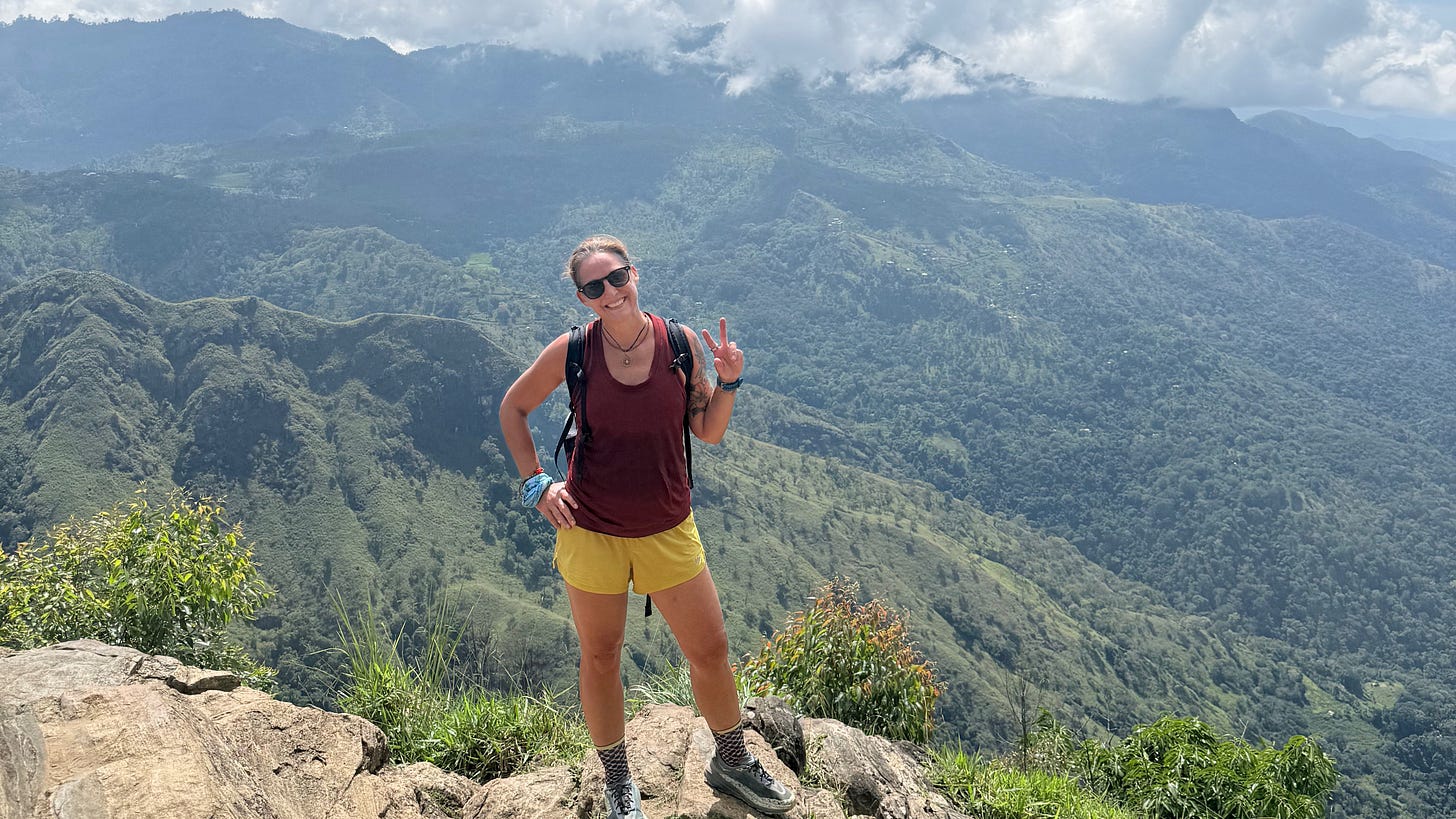 woman at the top of a mountain view woman at the top of a mountain view