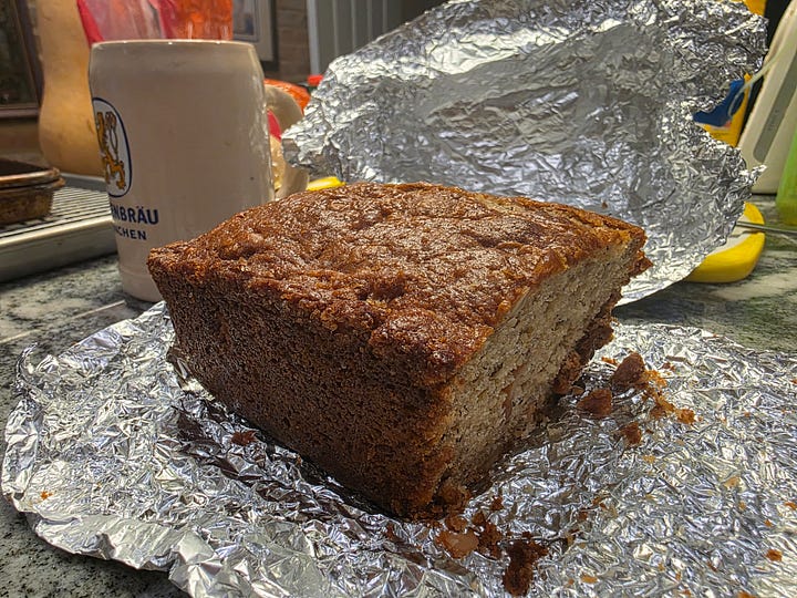 two banana bread photos, on the left a loaf on a white cooling rack. On the right, a loaf wrapped in foil that's had a slice taken.