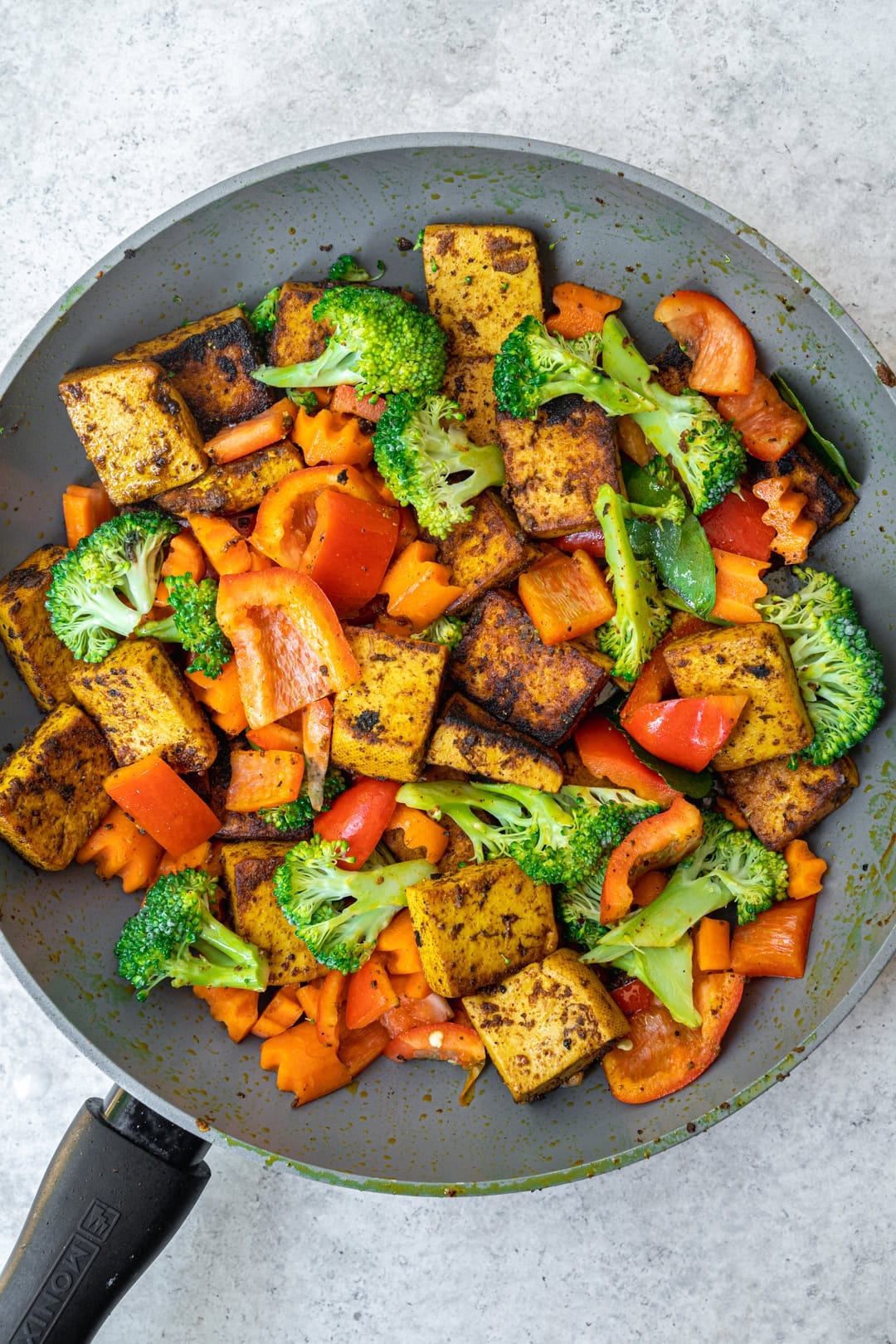 stir frying vegetables and marinated tofu