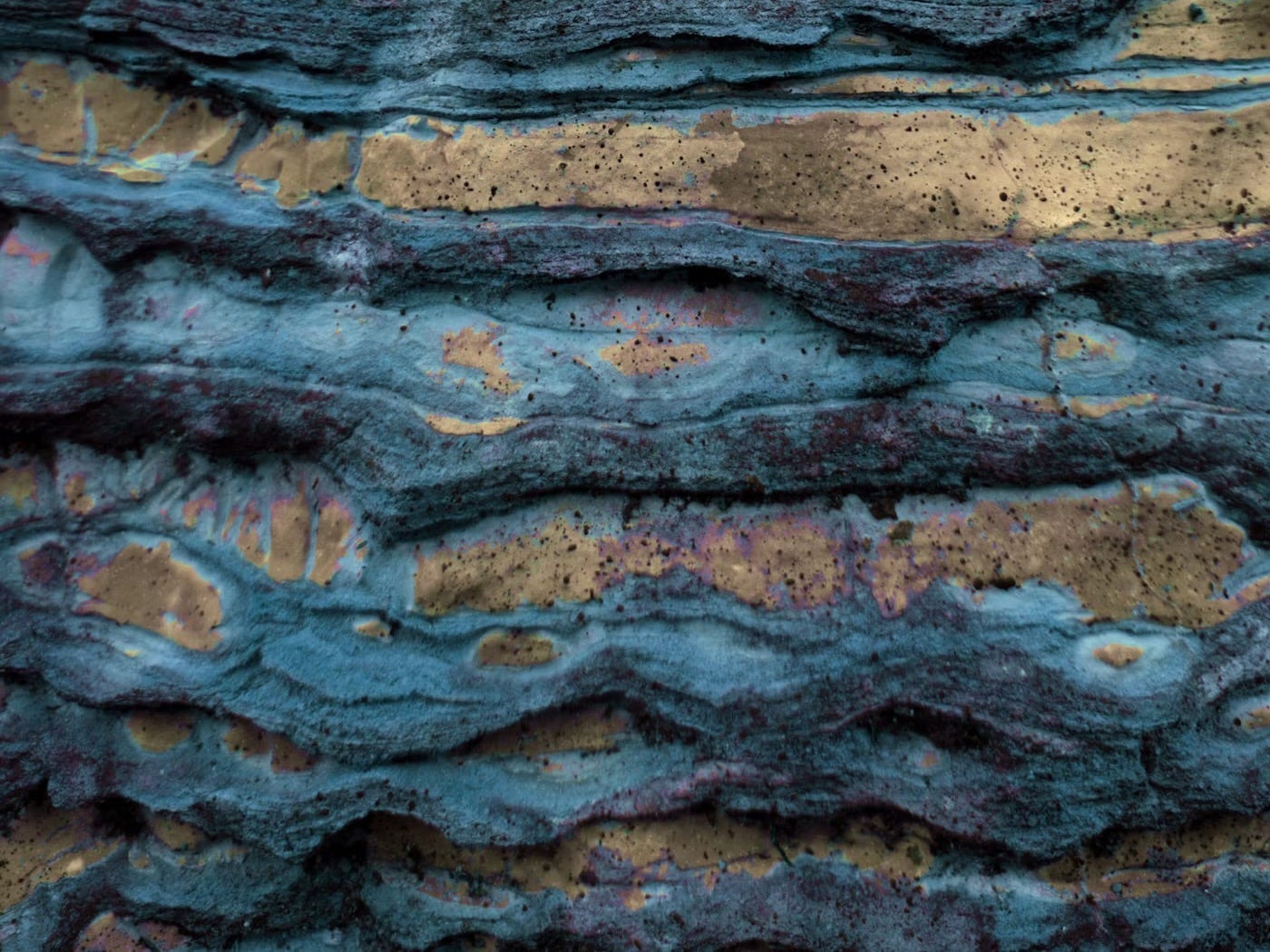 The Layer Beneath hero image for start here post. Layered rock representing the layers beneath real change.