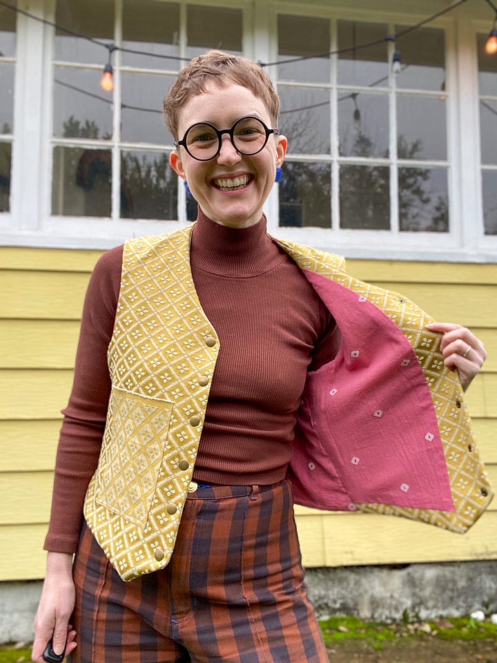 Me, a white woman with short hair and glasses, wearing a gold vest