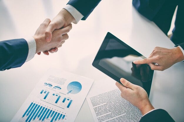 Free photo businessman with tablet after closing a deal Free photo businessman with tablet after closing a deal