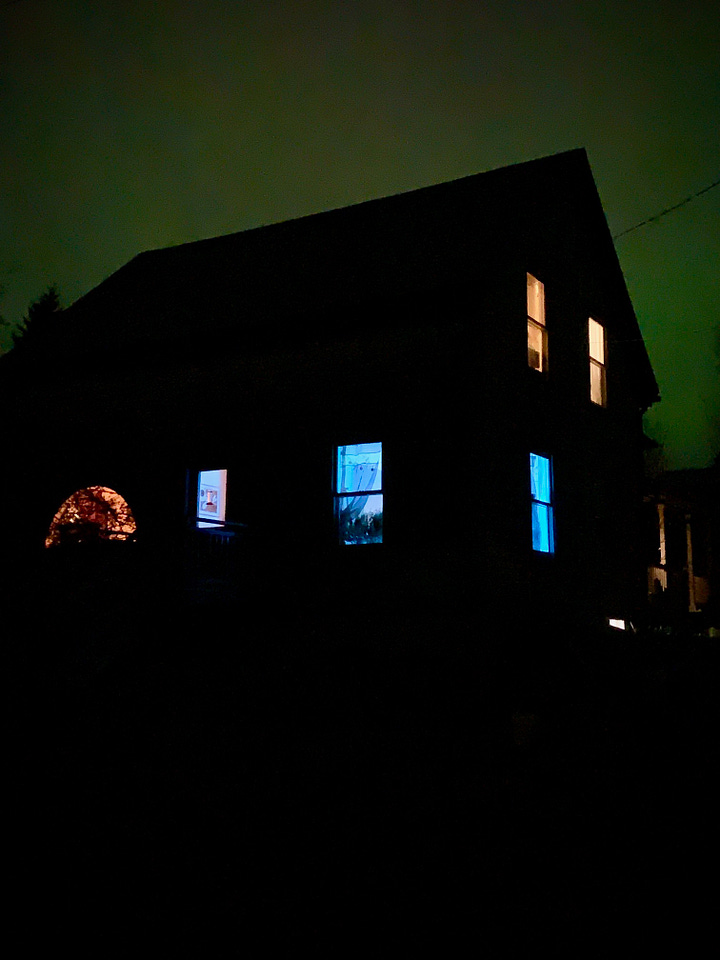 Photo one shows green and pink lights from Aurora borealis. Photo two shows green lights behind an old farmhouse at night.