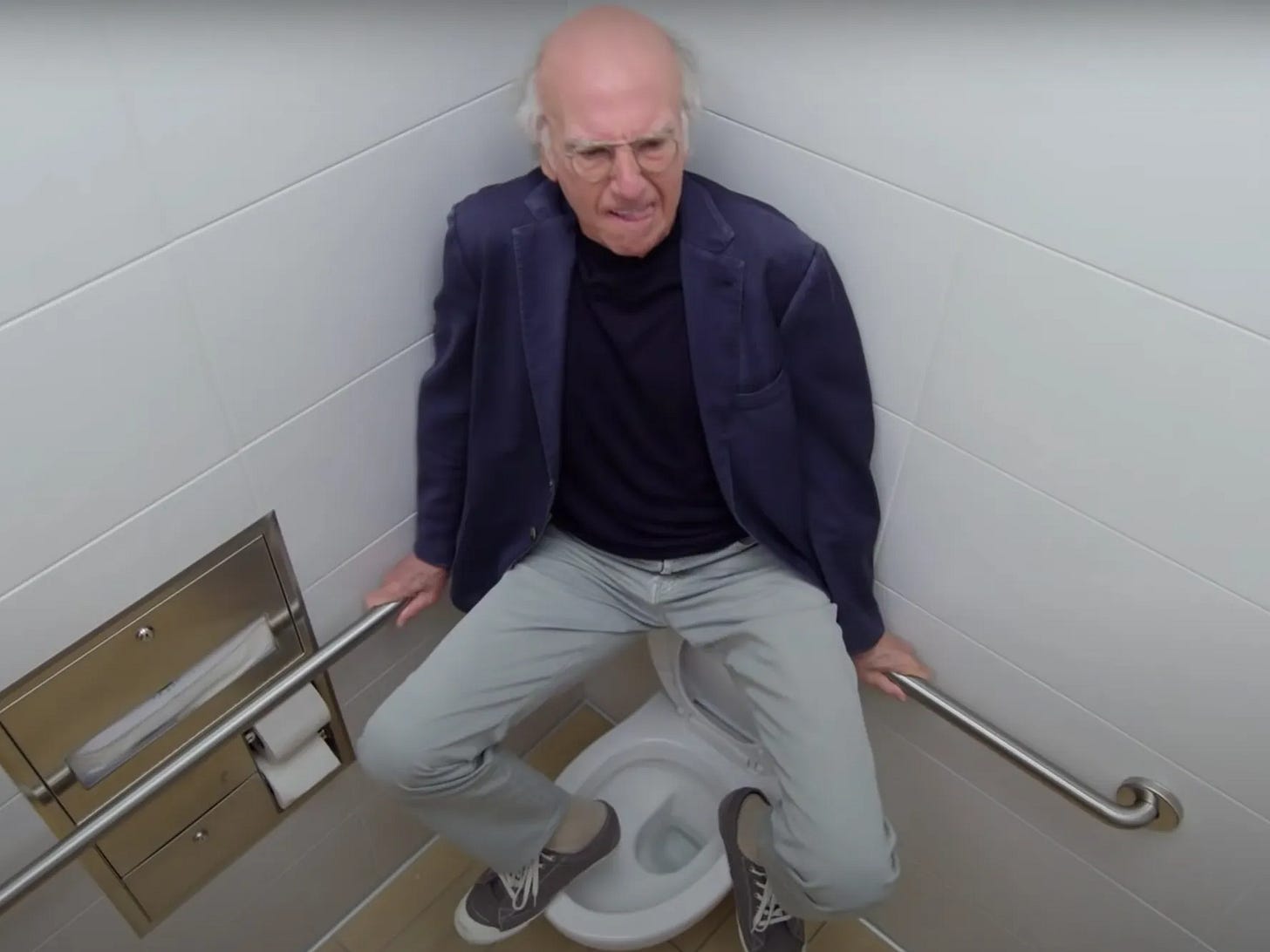 Larry David in Curb Your Enthusiasm sitting on a toilet