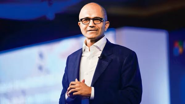 Satya Nadella speaking at an event, Microsoft CEO known for empathetic layoff memo. Satya Nadella speaking at an event, Microsoft CEO known for empathetic layoff memo.