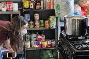Woman cooking in front of gas stove