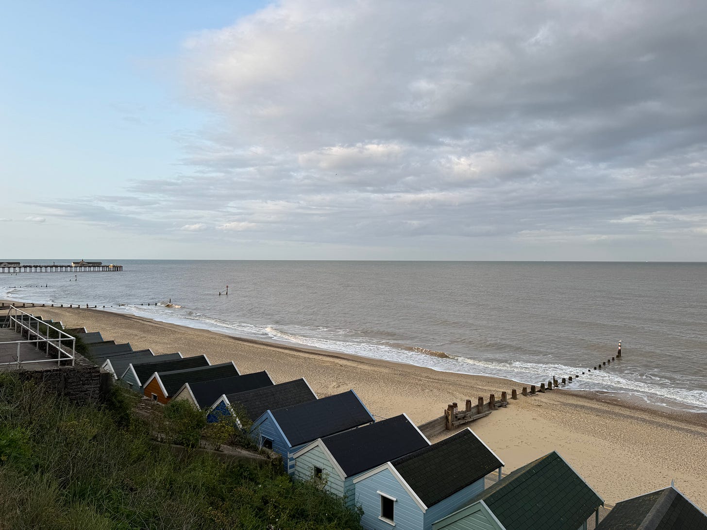View of the sea in Southwold with beach huts in the foreground
