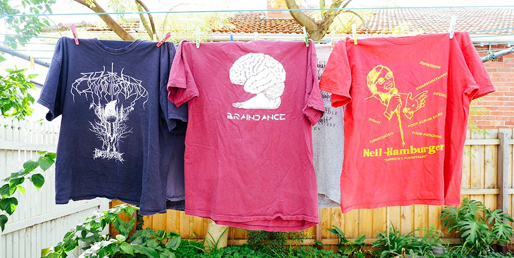 a black metal shirt, a shirt with a brain on it saying brain dance, and a Neil hamburger shirt