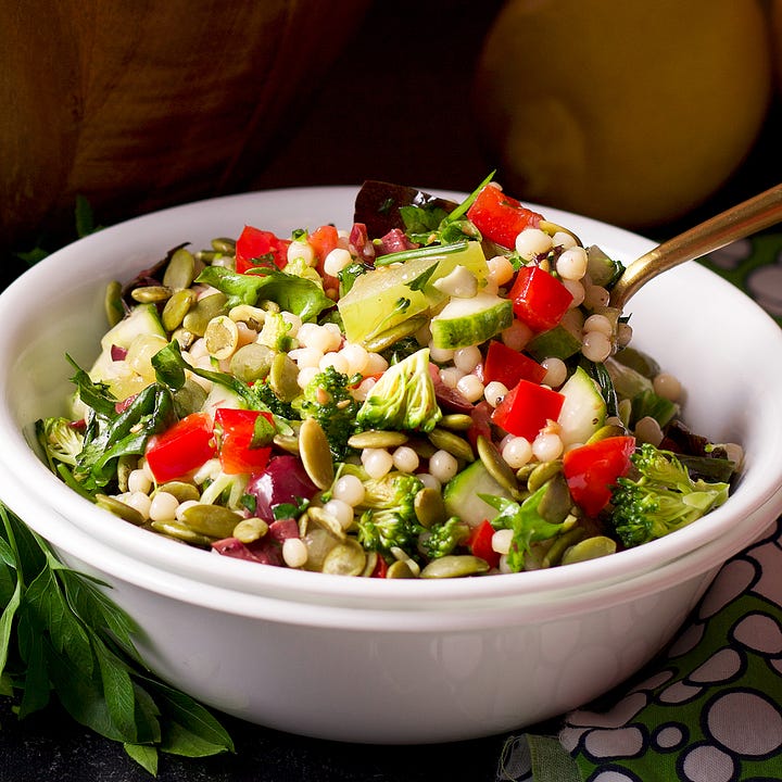 Couscous salad with fresh veggies, Israeli salad with pomegranate vinaigrette, a hummus platter, and a mediterranean chicken salad sandwich.