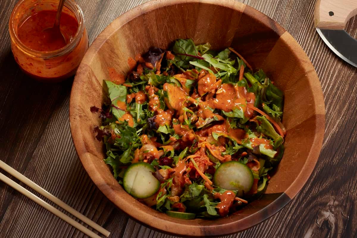 a big bowl of salad with gochujang salad dressing