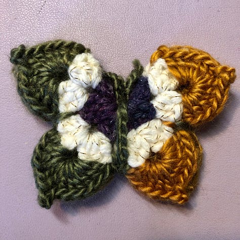 Nine multi-coloured crocheted butterflies
